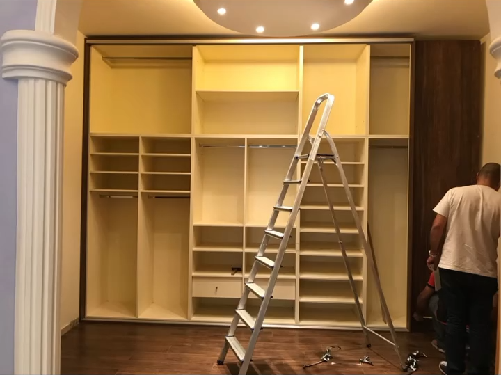 Cordahi craftsmen installing a walk-in closet